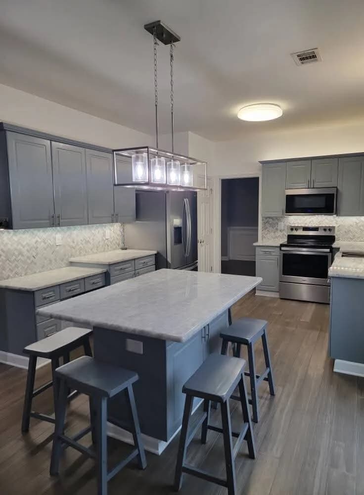 Cabinets, counters, tile, and trim done by one crew.