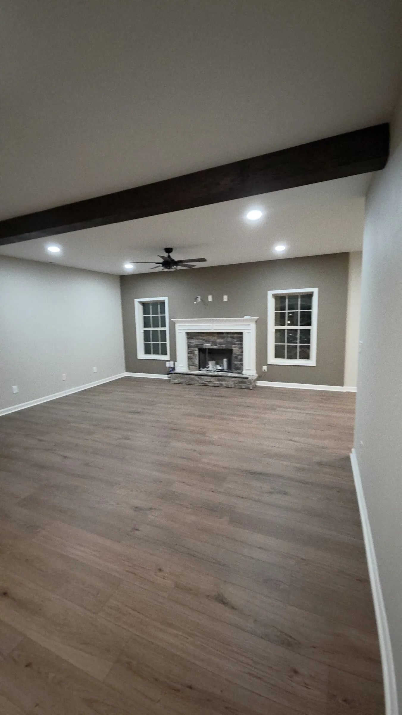 Finished basement with recessed lighting and wrapped beam in Newnan, GA